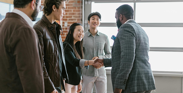 Small business partners greeting and closing a deal