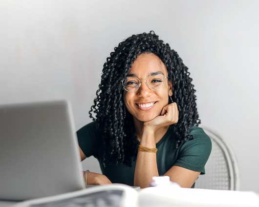 Entrepreneur smiling at her laptop