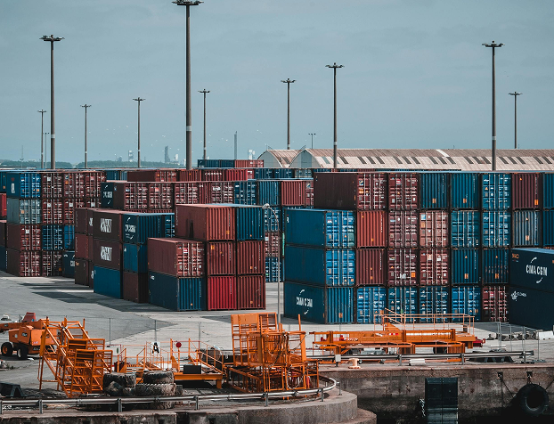 Stacks of shipping containers and port equipment